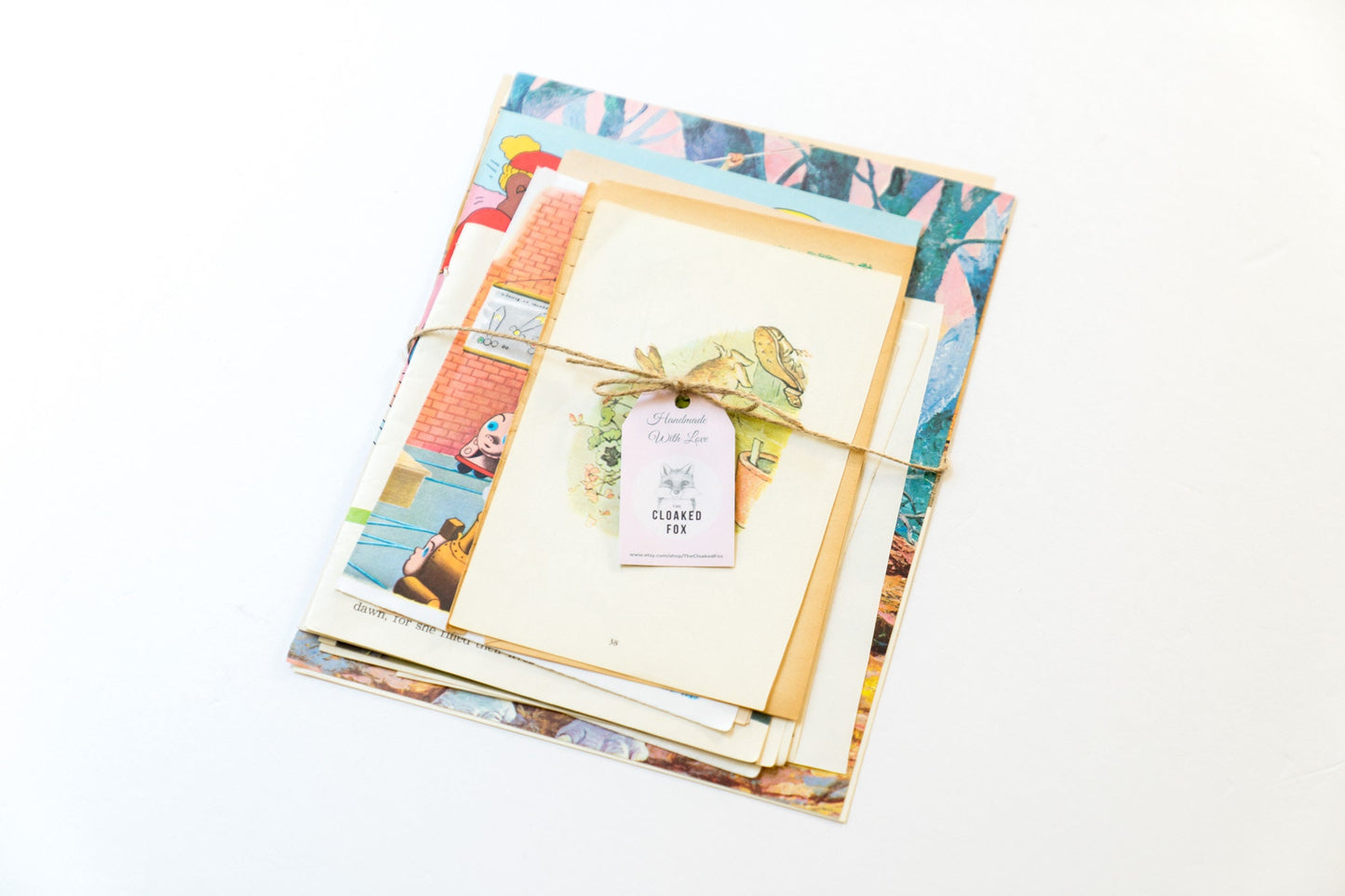 Flat lay showing close-up details of aged children’s book pages with whimsical artwork and yellowed paper edges.