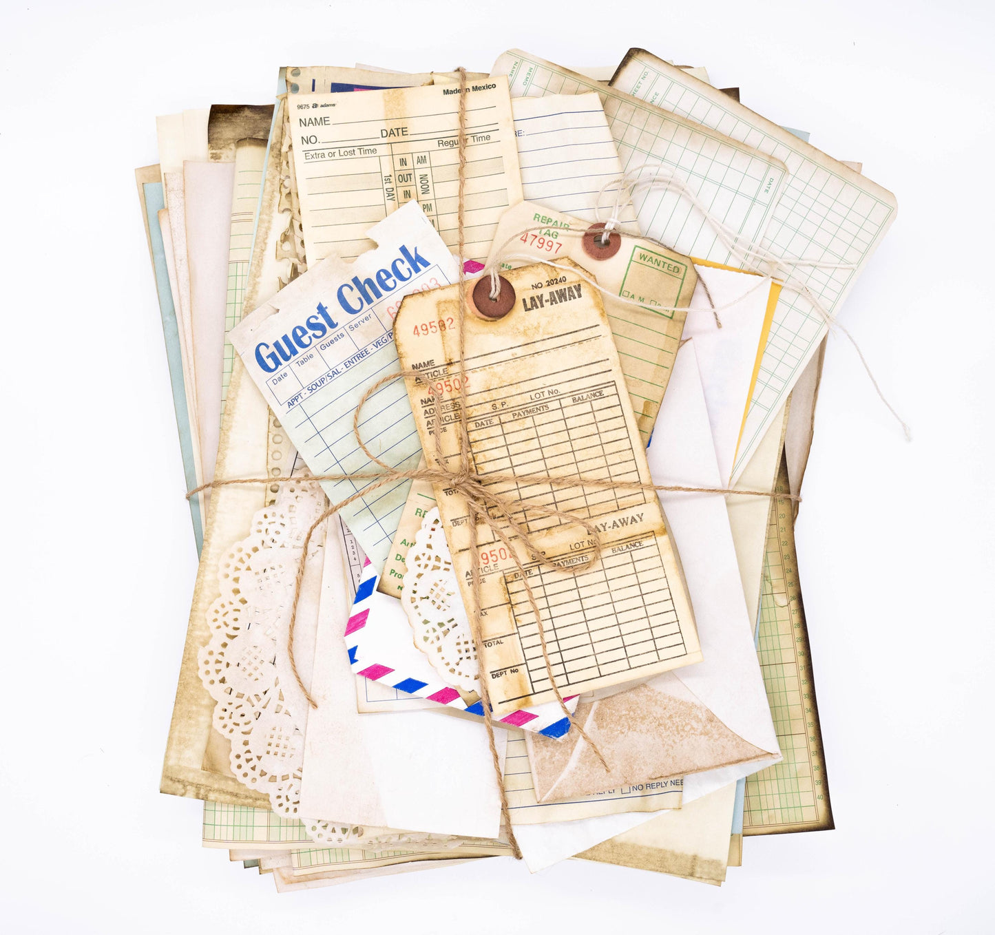 Flat lay of coffee-dyed vintage paper ephemera including ledger sheets, book pages, and tickets on a rustic background